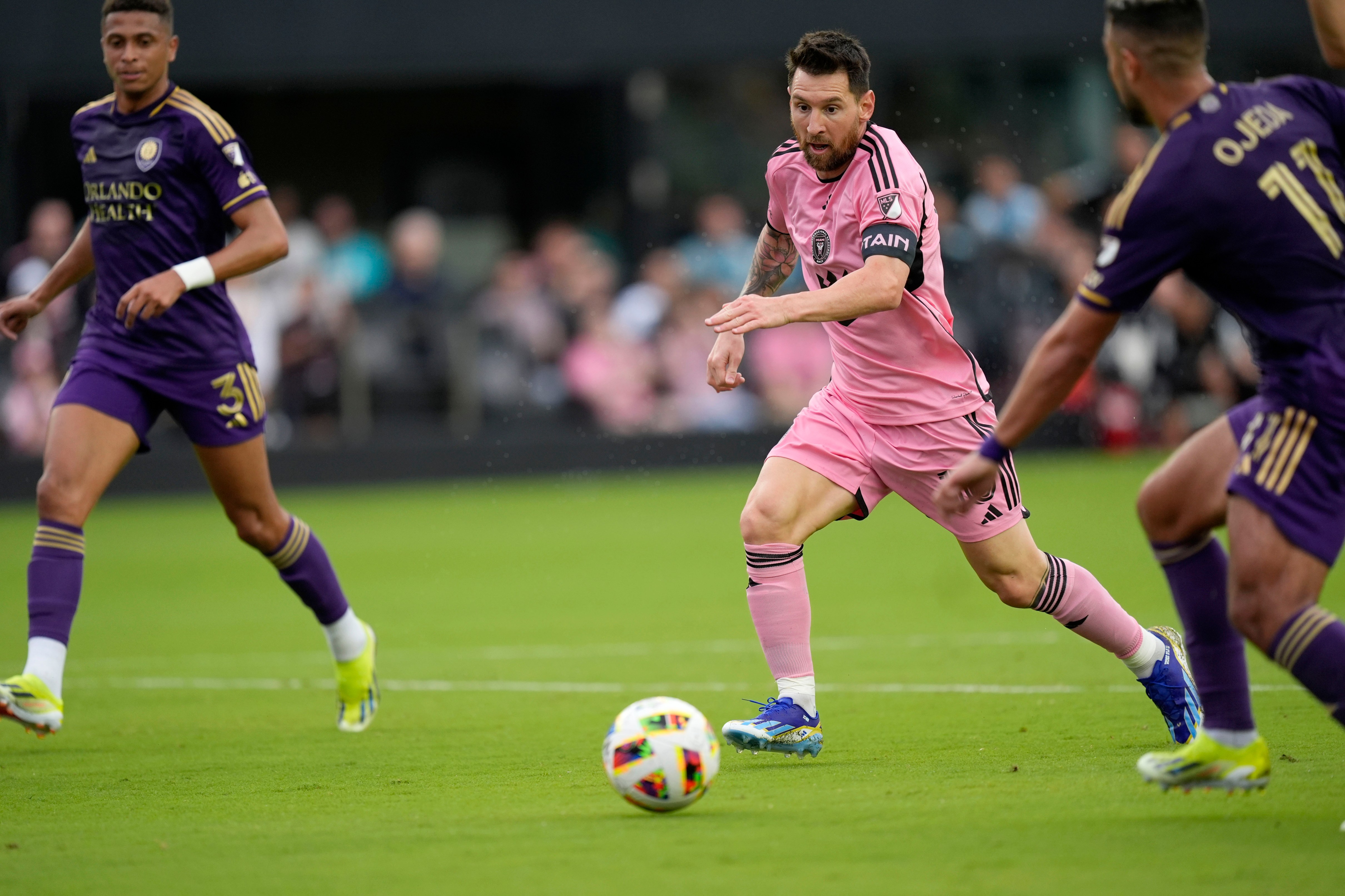 Inter Miami forward Lionel Messi (10) dribbles the ball under pressure from Orlando City midfielder Martín Ojeda (11) and Orlando City defender Rafael Santos (3) during the first half of an MLS soccer match, Saturday, March 2, 2024, in Fort Lauderdale, Fla. (AP Photo/Rebecca Blackwell)